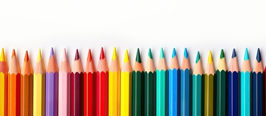 Poster - A colorful border of pencils is seen isolated on a white background forming a banner with copy space It features various drawing tools and supplies in multiple hues