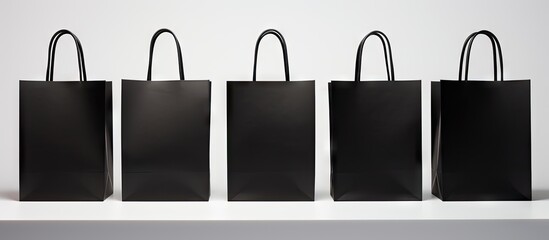 Aufkleber - A copy space image of a black shopping bag set against a white backdrop