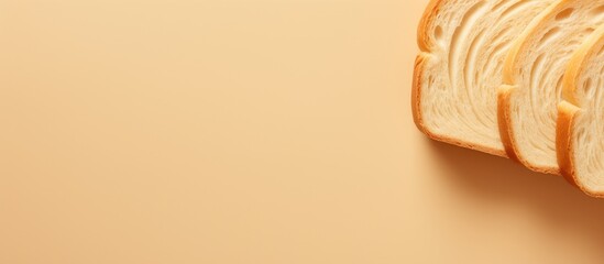 A close up top view of a beautiful big sliced bread on a cream color background perfect for design with copy space image