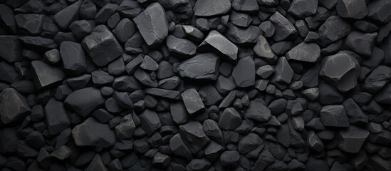 Poster - A dark background made of concrete adorned with stones creating an interesting and textured copy space image