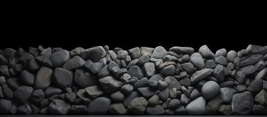 Poster - A dark background made of concrete adorned with stones creating an interesting and textured copy space image