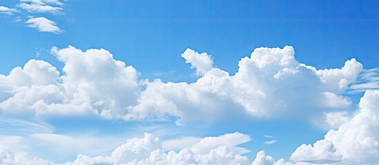 Poster - A background image featuring a clear blue sky adorned with fluffy white clouds Copy space available