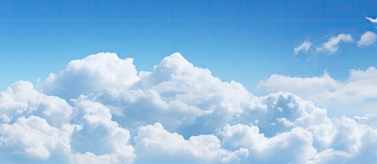 Poster - A background image featuring a clear blue sky adorned with fluffy white clouds Copy space available