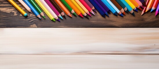 Poster - A copy space image of a white sheet of paper and six crayons placed on a wooden desk representing the back to school theme