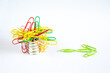 Business concept,recruitment,headhunting,start up and human resources concept with bulk of paper clips sticked to a magnet, the green ones leaving for new jobs, free copy space