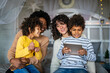Happy multiethnic family having fun with digital device at home. Family gadget technology concept.