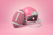 Pink American football helmet and ball
