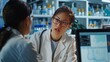 © Bi - Asian Female Scientist Using Desktop Computer And Talking To Caucasian Male Doctor In Medical Hospital Research Lab. Colleagues Discussing Test Results Of Patients, Treatment Methods, Medication