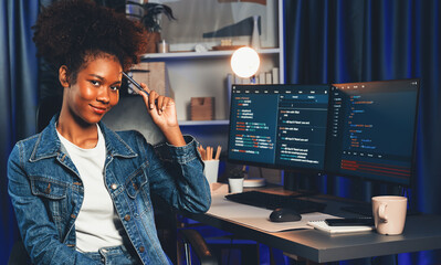 Wall Mural - Young African wearing jeans shirt, IT developer presenting program on computer screens displaying coded data of application and website, creating innovative updated software version. Tastemaker.