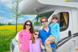 Family vacation, RV travel with kids, happy parents with children have fun on holiday trip in motorhome, camper exterior
