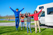 Family vacation, RV travel with kids, happy parents with children have fun on holiday trip in motorhome, camper exterior
