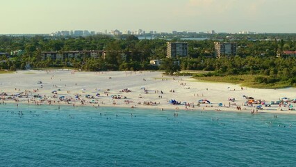 Wall Mural - Siesta Key beach in Sarasota, USA. Many people enjoying vacation time swimming in gulf water and relaxing on warm Florida sun