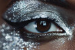 A detailed capture of a woman's eye with metallic silver eyeshadow, showcasing its modern and edgy aesthetic.