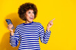 © deagreez - Portrait of pretty young woman indicate finger empty space wear striped shirt isolated on yellow color background