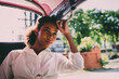 © tai - black traveling girl bored hot riding tuk tuk car on vacation. young african american tourist sitting exhausted tuk tuk ride. tired solo tourist girl sitting on tuk tuk transportation seat on sunny