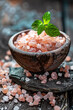 Pink himalayan salt in bowl on wooden table
