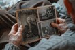 Close-up of an elderly person's hands holding weathered black-and-white family photographs, evoking feelings of nostalgia and memories of loved ones.