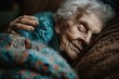 Close-up image of a serene elderly woman asleep, showcasing deep wrinkles and peaceful expression, covered with a vibrant knitted blanket.