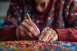 Close-up of elderly hands meticulously working on a vibrant bead craft project, highlighting creativity and dexterity in old age.