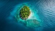 A drone shot of a small, picturesque island surrounded by a shimmering blue sea