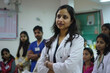 © AI_images - An Indian female doctor, radiating confidence, standing in front of a group of doctors, actively discussing patient diagnoses.