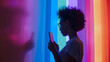Black woman standing in front of a rainbow wall PRIDE month and the LGBTQIA+ movement. 