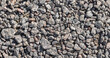 Gray gravel covering the ground top view, background texture
