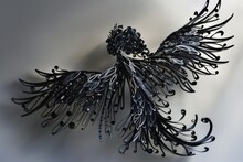 A Metal Sculpture Of A Bird With Black Feathers, Perfect For Interior Decor Or Garden Art