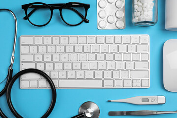 Wall Mural - Flat lay composition with keyboard and medical supplies on light blue background