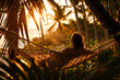 Woman Relaxing in a Hammock at Sunset on a Tropical Beach