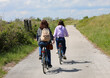 girl with her mother cycling in the cycle path during the outdoor excursion