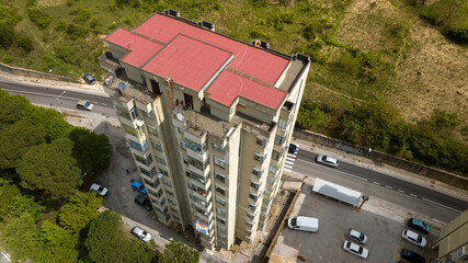 Aerial view of tenement house on the outskirts of a city in Italy. Italian public housing concept. Residential tower.