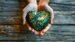 Hands hold heartshaped world map symbolizing saving Earth on Earth Day. Concept Earth Day, Saving the Planet, Environmental Awareness, Global Consciousness