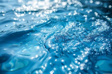Poster - Close-up shot of clear water with glistening sunlight reflecting on its surface and air bubbles rising, showing the serenity and purity of nature
