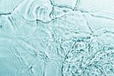 Fototapeta  - Water waves on blue background. Top view with copy space.