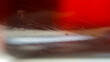 Scratches and dirt on transparent glass on blurred red and dark.