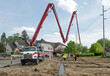 Construction Crew Pumping Concrete into Housing Development Footer