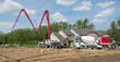 Construction Site with Concrete and Boom Pump Trucks
