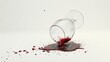   Red liquid pours from a wine glass onto a white surface, spilling and creating a droplet of red liquid