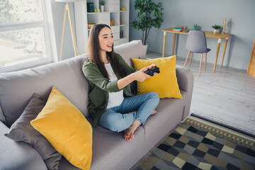 Canvas Print - Full length portrait of nice young girl play video games wear green shirt modern interior flat indoors