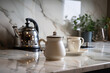 A marble countertop with two cups and a kettle placed on it in a kitchen setting
