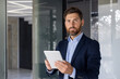 © Tetiana - Confident businessman with tablet in modern office setting