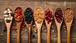 Assortment of beans and lentils in wooden spoon on wooden background. mung bean, groundnut, soybean, red kidney bean , black bean ,red bean and brown pinto beans .