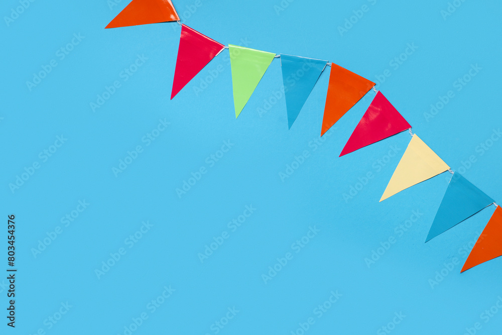 Colorful flags for Festa Junina celebration on color background