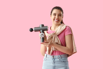 Sticker - Young woman holding percussive massager with bow on pink background