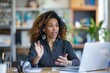 © Lucija - woman participating in video call or virtual meeting gesturing while talking modern office setting