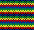 Bright seamless knitted texture. The pattern is crocheted from multi-colored cotton yarn. Zigzag shapes. African motives. 