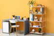 © Pixel-Shot - Stylish workplace with laptop near bookcase in stylish room