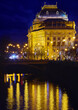Prague, Czech Republic. Nighttime view at National Theater (Narodni Divadlo) on the promenade of river Vltava bridge, evening illumination and street lamps. Urban landscape. Popular travel destination
