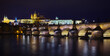 Prague, Czech Republic. Charles Bridge. Panoramic view at Prague Castle in the old town district. Ancient towers and illuminated houses. Famous travel destination Europe.